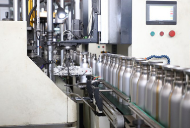 a clean, modern factory line showing the manufacturing of stainless steel bottles