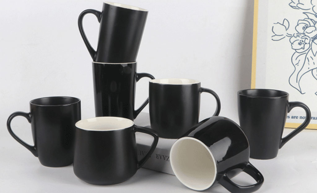 a collection of stylish ceramic mugs in various colors on a shelf