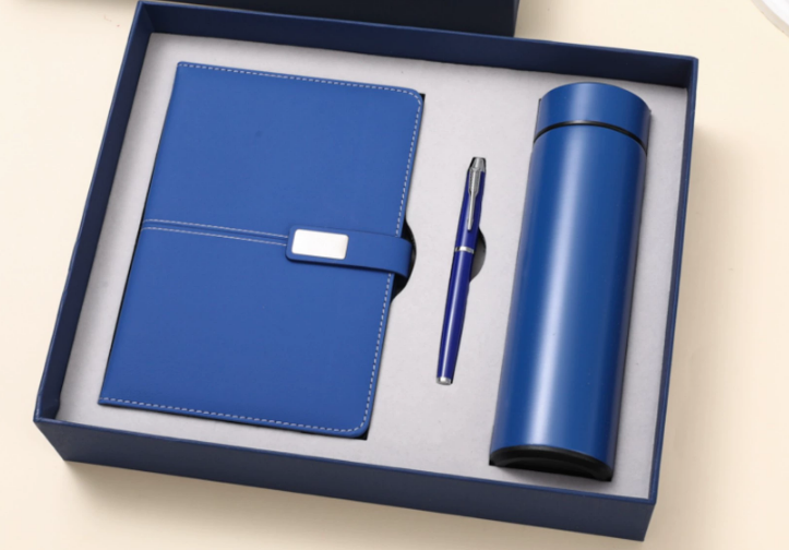 a curated selection of high-quality corporate gifts including a leather notebook, a premium pen, and a stainless steel water bottle