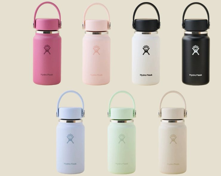 a close-up of a laser engraving machine precisely etching a name onto a matte black stainless steel water bottle