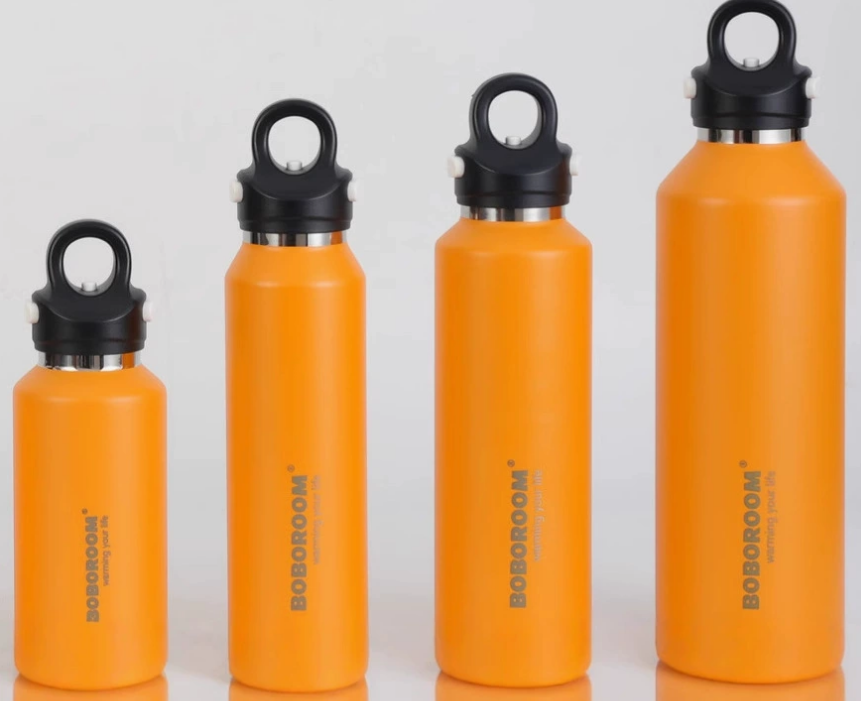 a row of elegant stainless steel bottles with a modern company logo laser-engraved on them