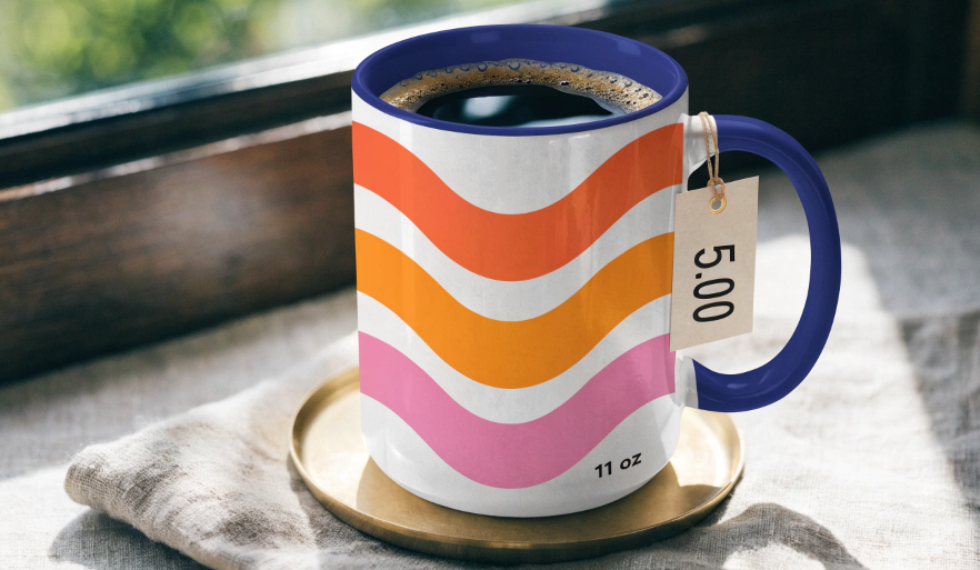 A tag with a price on it hanging from the handle of a custom coffee mug
